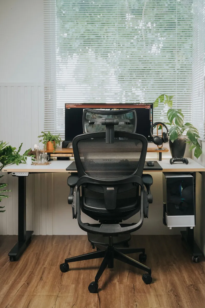 Modern ergonomic home office with standing desk and mesh chair
